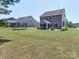 Spacious backyard with well-maintained lawn, trampoline, and patio, perfect for outdoor activities at 5797 Mcclintock Dr, Denver, NC 28037