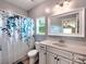 Bathroom featuring a patterned shower curtain, vanity with storage, and natural light at 5797 Mcclintock Dr, Denver, NC 28037