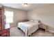 Comfortable bedroom with neutral walls and carpet features a queen-size bed and side tables at 5797 Mcclintock Dr, Denver, NC 28037