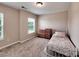 This cozy bedroom with neutral walls features a window and carpeted floor at 5797 Mcclintock Dr, Denver, NC 28037