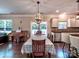 Bright dining area with a modern chandelier and access to the outdoor living space at 5797 Mcclintock Dr, Denver, NC 28037