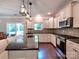 Kitchen with a granite island, stainless steel appliances, ample cabinetry, and tile backsplash at 5797 Mcclintock Dr, Denver, NC 28037