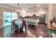 Eat-in kitchen with stainless appliances, central island with seating, and glass sliding doors at 5797 Mcclintock Dr, Denver, NC 28037