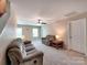 Bright, neutral living room features plush sofas, side table and ceiling fan at 5797 Mcclintock Dr, Denver, NC 28037