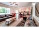 Open floor plan showing living room with hardwood floors, sofas, piano, and view to dining area and kitchen at 5797 Mcclintock Dr, Denver, NC 28037