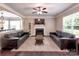 Spacious living room with a fireplace, ceiling fan, and abundant natural light at 5797 Mcclintock Dr, Denver, NC 28037