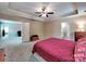 Spacious primary bedroom features a tray ceiling, ceiling fan, and multiple closets at 5797 Mcclintock Dr, Denver, NC 28037