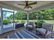 Inviting screened porch with comfortable seating, a rug, and a view of the landscaped backyard at 5797 Mcclintock Dr, Denver, NC 28037