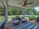 Relaxing screened porch with chairs and a view of the backyard with trampoline at 5797 Mcclintock Dr, Denver, NC 28037