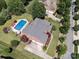 Aerial view of a backyard with pool and gazebo surrounded by mature trees at 6523 Alba Rose Ln, Huntersville, NC 28078