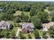 Aerial view of a home with mature trees, showcasing landscaping and neighborhood at 6523 Alba Rose Ln, Huntersville, NC 28078