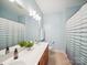 Bathroom featuring a double sink vanity and striped shower curtain at 6523 Alba Rose Ln, Huntersville, NC 28078