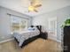 Cozy bedroom featuring a ceiling fan and a window with natural light at 6523 Alba Rose Ln, Huntersville, NC 28078