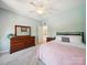 Inviting bedroom with warm natural lighting and wood dresser, great storage at 6523 Alba Rose Ln, Huntersville, NC 28078