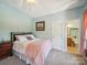 Bright bedroom complemented by a connected bathroom, creating a private suite at 6523 Alba Rose Ln, Huntersville, NC 28078