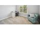 Cozy bedroom is furnished with a desk and chair and a comfortable armchair at 6523 Alba Rose Ln, Huntersville, NC 28078
