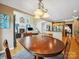 Elegant dining area featuring hardwood floors, a chandelier, and seamless access to the living and kitchen spaces at 6523 Alba Rose Ln, Huntersville, NC 28078
