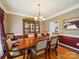 Elegant dining room with hardwood floors, chandelier, and classic china cabinet at 6523 Alba Rose Ln, Huntersville, NC 28078