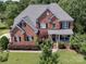 Aerial view showcasing the brick exterior and landscaped yard of this home at 6523 Alba Rose Ln, Huntersville, NC 28078