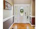 Welcoming foyer with decorative front door, hardwood floors, and stylish decor at 6523 Alba Rose Ln, Huntersville, NC 28078