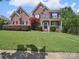 Charming two-story brick home with manicured lawn and inviting front porch at 6523 Alba Rose Ln, Huntersville, NC 28078