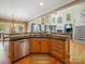 Gourmet kitchen with stainless steel appliances, a breakfast bar, and an open view to the living area at 6523 Alba Rose Ln, Huntersville, NC 28078