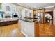Modern kitchen open to living room, stainless appliances, breakfast bar and hardwood flooring throughout at 6523 Alba Rose Ln, Huntersville, NC 28078