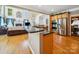 Open-concept kitchen with stainless steel appliances, granite countertops, and seamless flow to the living room at 6523 Alba Rose Ln, Huntersville, NC 28078