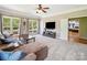 Open living room features a wall-mounted TV and entry to the main bedroom at 6523 Alba Rose Ln, Huntersville, NC 28078
