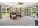 Spacious living room features a large window array and a comfortable sectional sofa at 6523 Alba Rose Ln, Huntersville, NC 28078