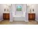 Main bathroom with a large tub, columns, and stained glass window at 6523 Alba Rose Ln, Huntersville, NC 28078