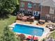 Aerial view of a backyard with pool, deck, hot tub, and seating area at 6523 Alba Rose Ln, Huntersville, NC 28078