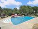 Beautiful backyard pool surrounded by lush landscaping and relaxing lounge areas at 6523 Alba Rose Ln, Huntersville, NC 28078