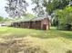 Classic brick home with a charming facade, manicured lawn, and mature trees providing ample shade and privacy at 6539 Louglen Cir, Charlotte, NC 28212