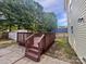 Wooden deck overlooking the expansive backyard with mature trees, perfect for outdoor entertaining and relaxation at 745 Erin Brook Ct, York, SC 29745