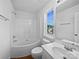 Clean bathroom featuring white fixtures, a shower-tub combo, and a bright window at 745 Erin Brook Ct, York, SC 29745