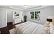Well-lit bedroom with a large window, sleek furniture, and ensuite bathroom, virtually staged at 745 Erin Brook Ct, York, SC 29745