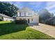 Charming two-story home with an attached garage, a well-maintained lawn, and a inviting front porch at 745 Erin Brook Ct, York, SC 29745
