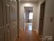 Hallway with wood floors leading to a bedroom with natural light at 833 21St Ne Ave # 833, Hickory, NC 28301