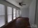 Bright sunroom with brick flooring, ceiling fan, and abundant natural light at 833 21St Ne Ave # 833, Hickory, NC 28301