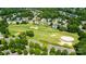 Aerial view features a neighborhood bordering a golf course with many sand traps at 8538 Highland Glen Dr, Charlotte, NC 28269