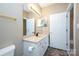 Bathroom with a white cabinet, a sink, and a white door at 8538 Highland Glen Dr, Charlotte, NC 28269