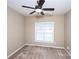 Well-lit, carpeted bedroom with ceiling fan and window, offering a blank canvas for personalization and decor at 8538 Highland Glen Dr, Charlotte, NC 28269