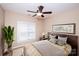 Comfortable bedroom with a large window, ceiling fan, and modern decor, perfect for relaxation and rest at 8538 Highland Glen Dr, Charlotte, NC 28269