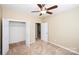 This is a cozy bedroom with a ceiling fan, carpet, and an open closet at 8538 Highland Glen Dr, Charlotte, NC 28269