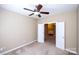 Neutral bedroom with carpet flooring and ceiling fan, offering a versatile space with access to additional living areas at 8538 Highland Glen Dr, Charlotte, NC 28269