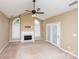Large living room with a fireplace, neutral walls, and lots of natural light at 8538 Highland Glen Dr, Charlotte, NC 28269