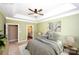 Main bedroom featuring en-suite bathroom access, a tray ceiling and a neutral color palette, offering a peaceful haven at 8538 Highland Glen Dr, Charlotte, NC 28269