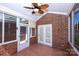 Sunroom featuring brick walls, tile flooring, a fan, and glass doors at 8538 Highland Glen Dr, Charlotte, NC 28269
