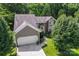 Beautiful home with lush greenery, a two-car garage, and a well-maintained lawn at 10043 Elsenham Ln, Charlotte, NC 28269